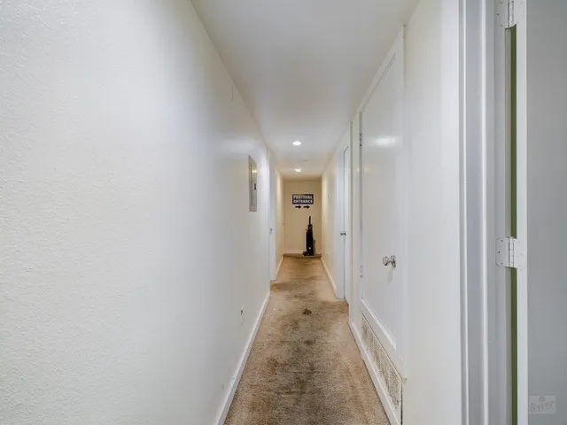a view of a hallway with a white door