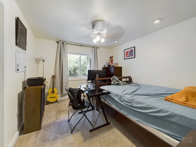 a bed room with furniture and a window