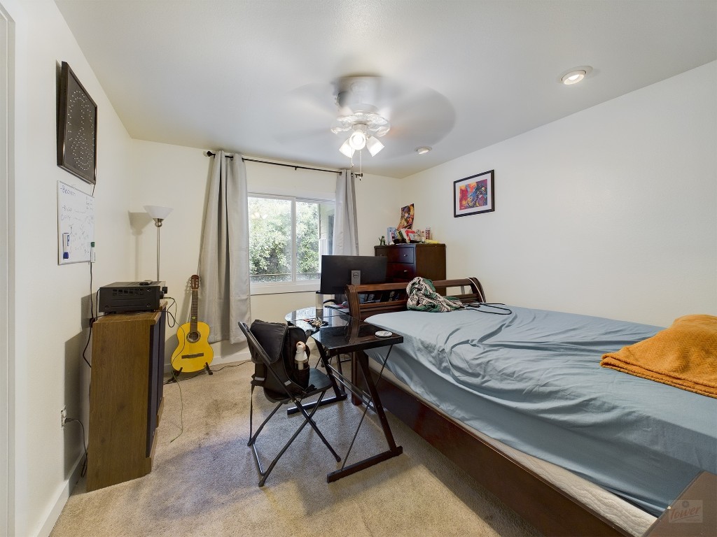 915 Keith Lane, Unit 104 Austin, TX 78705 - Photo 9 of 14 a bed room with furniture and a window