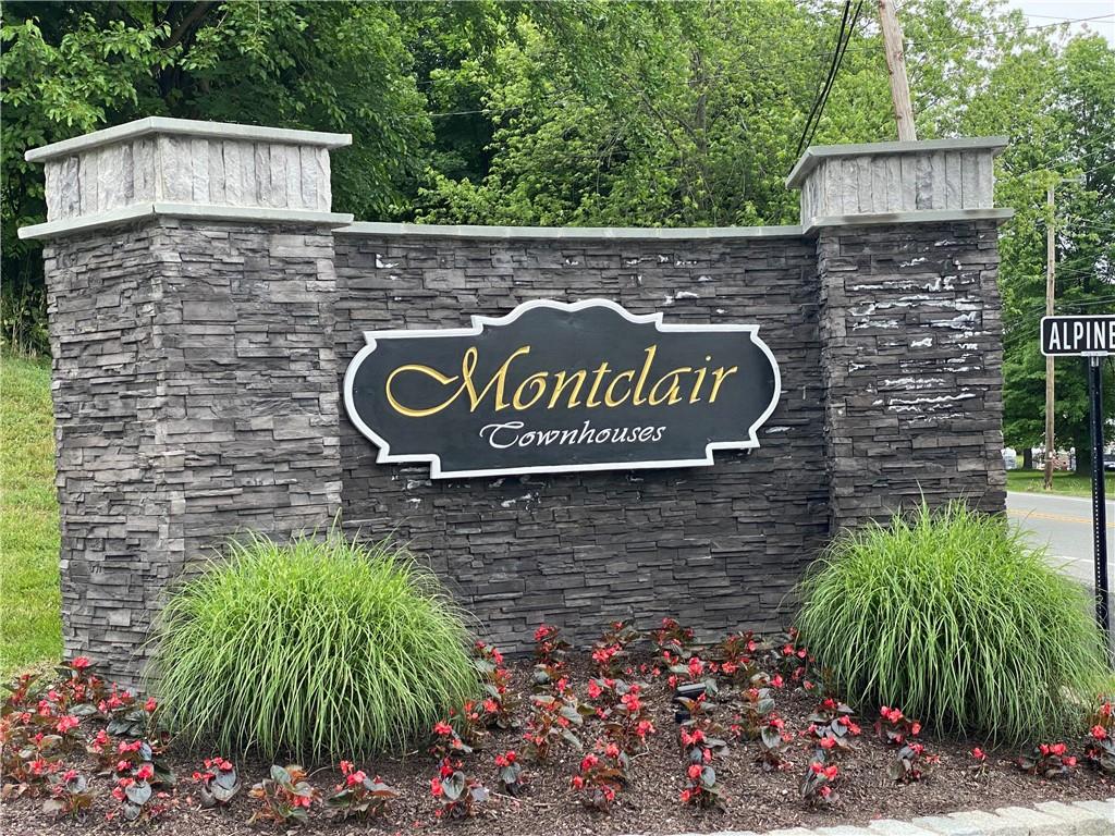 33 Alpine Drive, Unit C Wappingers Falls, NY 12590 - Photo 1 of 1 a sign that is sitting in front of flowers