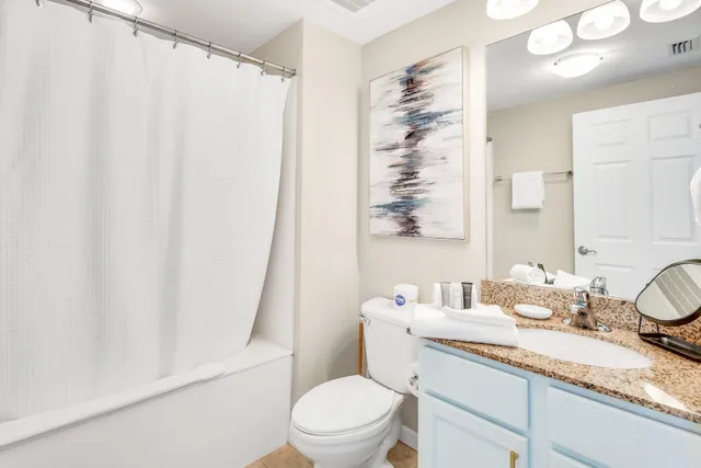 a bathroom with a toilet sink and shower