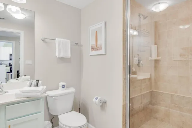 a bathroom with a granite countertop sink a mirror and vanity
