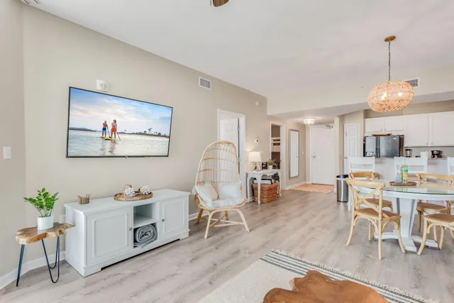 a living room with furniture a dining table and a potted plant