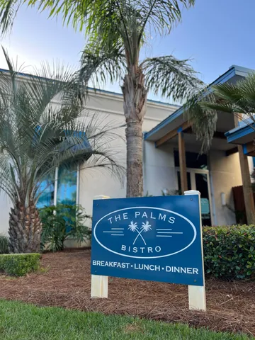 a blue couch sitting next to a window