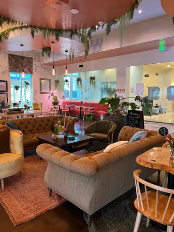 a outdoor living space with furniture potted plant and a large window