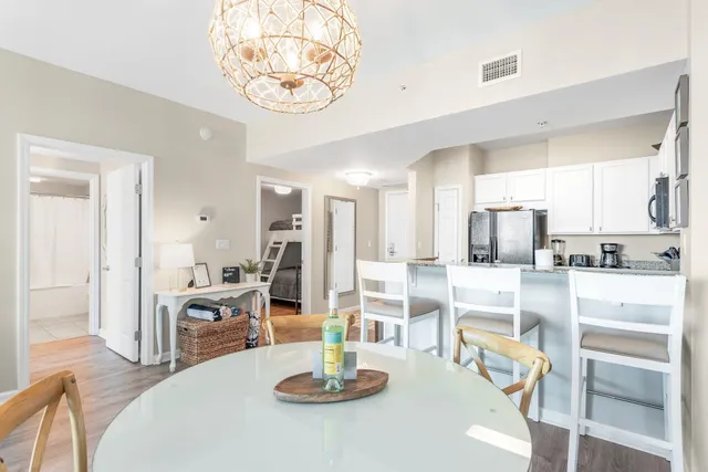 a kitchen with a table chairs and white cabinets