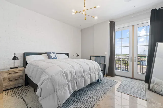 a bedroom with a large bed and a balcony