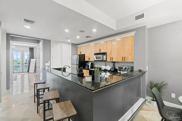 a kitchen with sink refrigerator and microwave