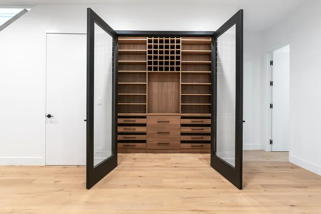 a view of empty room with wooden floor