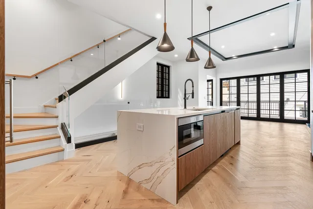 a view of a kitchen with a stove and a wooden floors