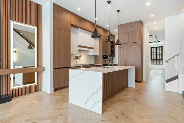 a kitchen with stainless steel appliances granite countertop a stove and a refrigerator