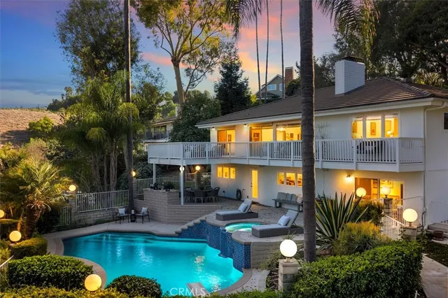 a view of a house with a yard and potted plants