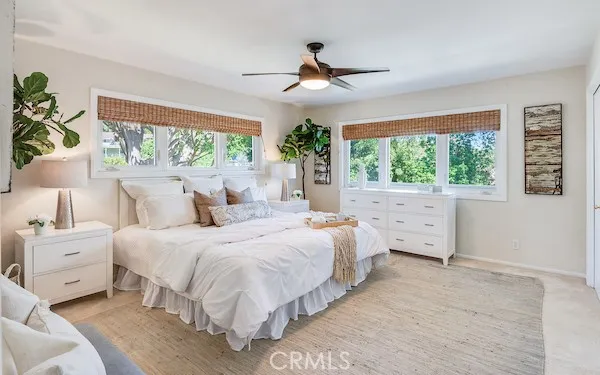 a bedroom with a bed and a lamp with window