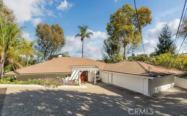 a living room with furniture a flat screen tv and floor to ceiling window