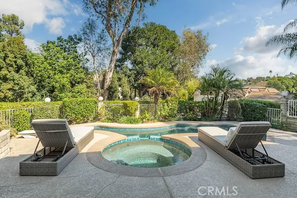 an aerial view of a house with a yard and trees
