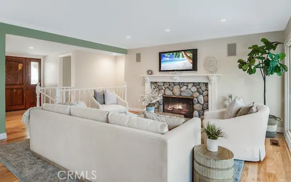 a roof deck with couches and wooden floor