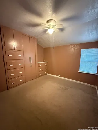 a view of an empty room with a fan