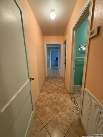 a view of hallway with stairs and wooden floor