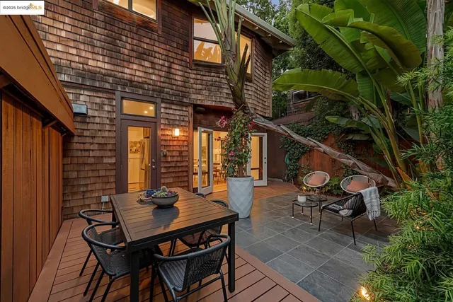 a backyard of a house with table and chairs