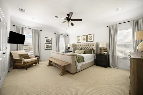 a bedroom with bed couch and window