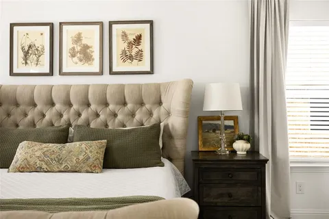 a living room with furniture and painting on the wall