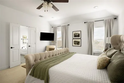 a bedroom with a bed and a flat screen tv