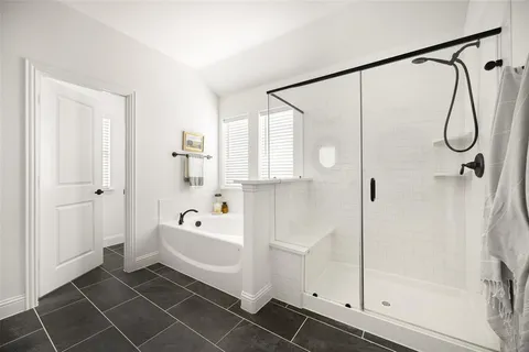 a bathroom with a bathtub and a shower