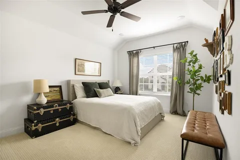 a bedroom with a bed window and couch