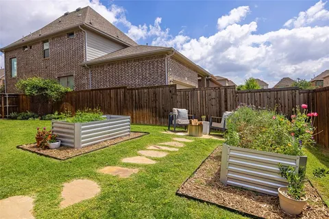 a view of a backyard with plants garden and patio