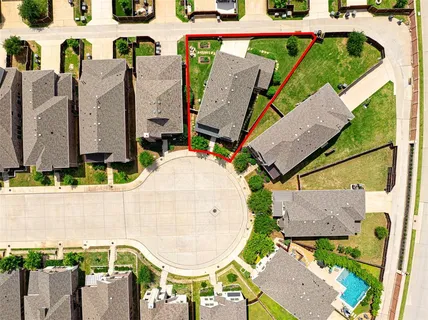 an aerial view of a house with a swimming pool