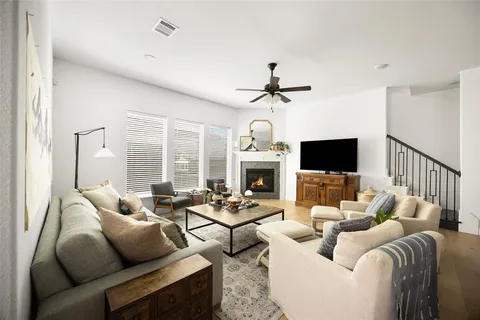 a living room with furniture a fireplace and a flat screen tv