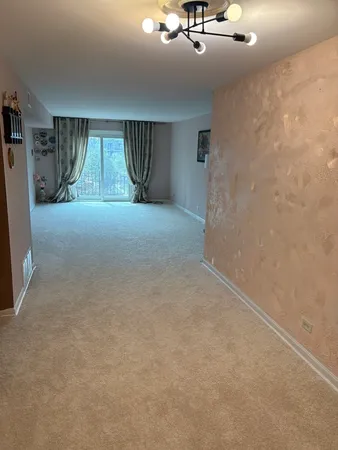 a view of empty room with a fireplace