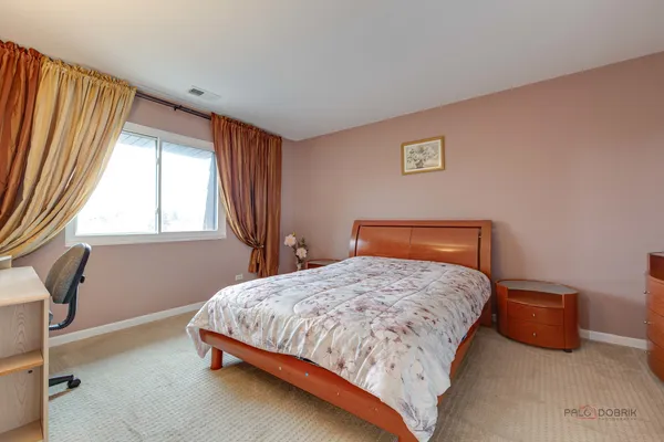 a bedroom with a bed and window