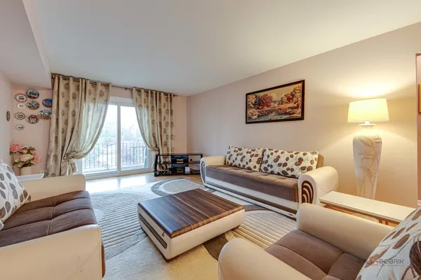 a living room with furniture and a large window