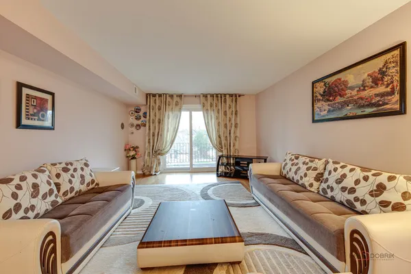 a living room with furniture and a large window