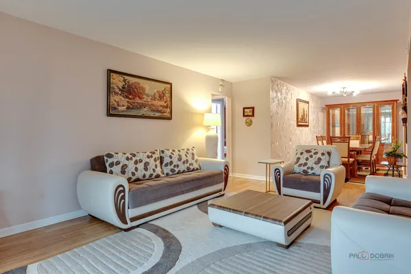 a living room with furniture rug and wooden floor