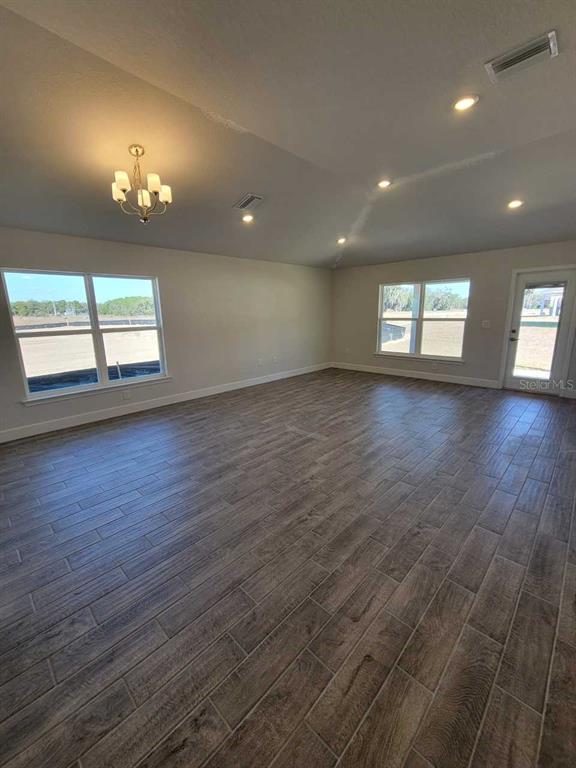 4513 Southwest 91st Ln Road Ocala, FL 34476 - Photo 13 of 36 an empty room with wooden floor and windows