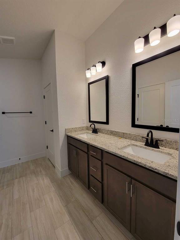 4513 Southwest 91st Ln Road Ocala, FL 34476 - Photo 15 of 36 a bathroom with double vanity sink and a mirror