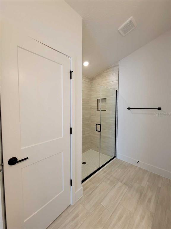 4513 Southwest 91st Ln Road Ocala, FL 34476 - Photo 16 of 36 a bathroom with a shower and a glass door