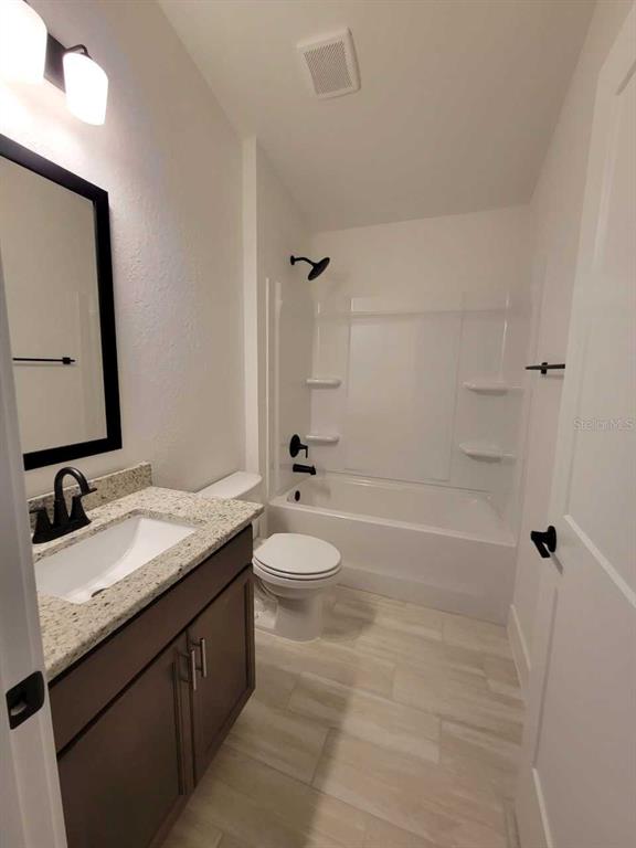 4513 Southwest 91st Ln Road Ocala, FL 34476 - Photo 20 of 36 a bathroom with a granite countertop sink toilet and shower