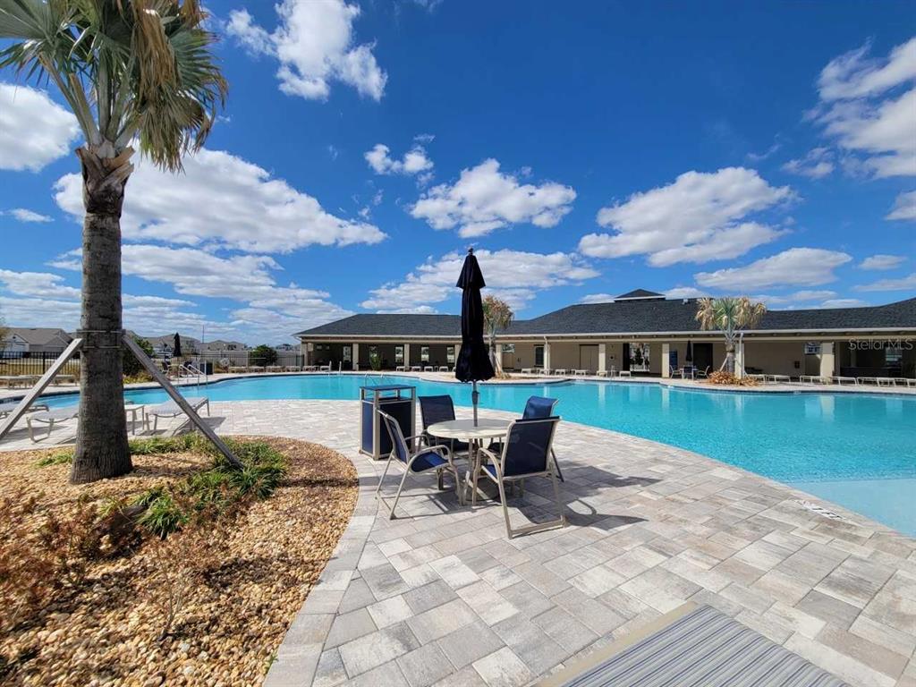 4513 Southwest 91st Ln Road Ocala, FL 34476 - Photo 23 of 36 a front view of a house with a yard