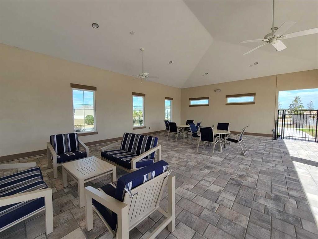 4513 Southwest 91st Ln Road Ocala, FL 34476 - Photo 30 of 36 a living room with furniture a wooden floor and a chandelier