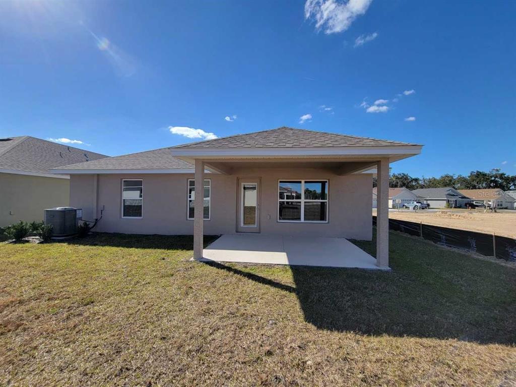 4513 Southwest 91st Ln Road Ocala, FL 34476 - Photo 3 of 36 a front view of a house with a yard