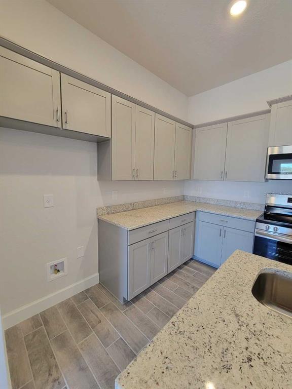 4513 Southwest 91st Ln Road Ocala, FL 34476 - Photo 7 of 36 a kitchen with a sink cabinets and appliances