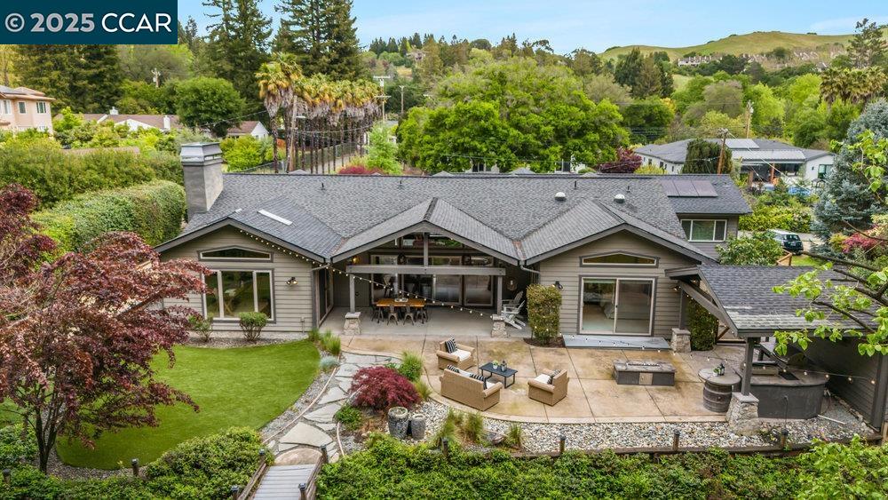 an aerial view of a house with garden space and street view