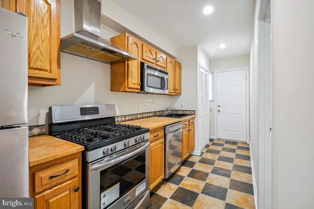 a kitchen with stainless steel appliances granite countertop a stove and a sink