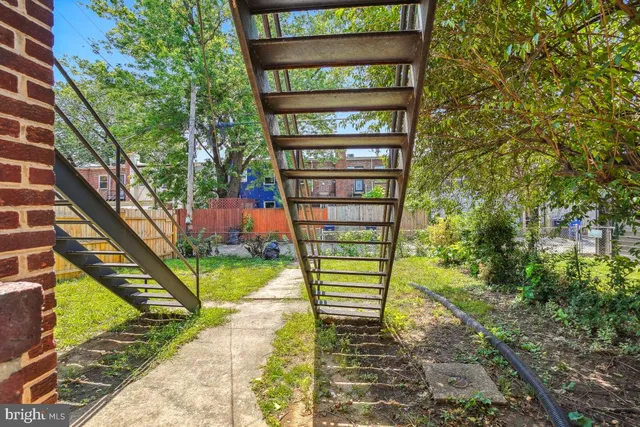 a green field with trees in front of it