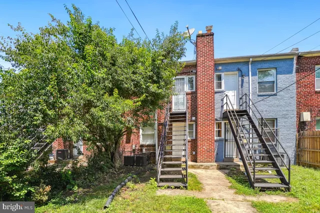 front view of a house with a tree
