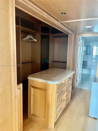 a living room with stainless steel appliances wooden floor and a faucet
