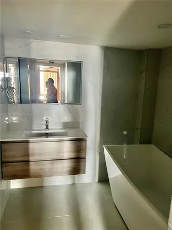 a white toilet sitting next to a bathroom sink